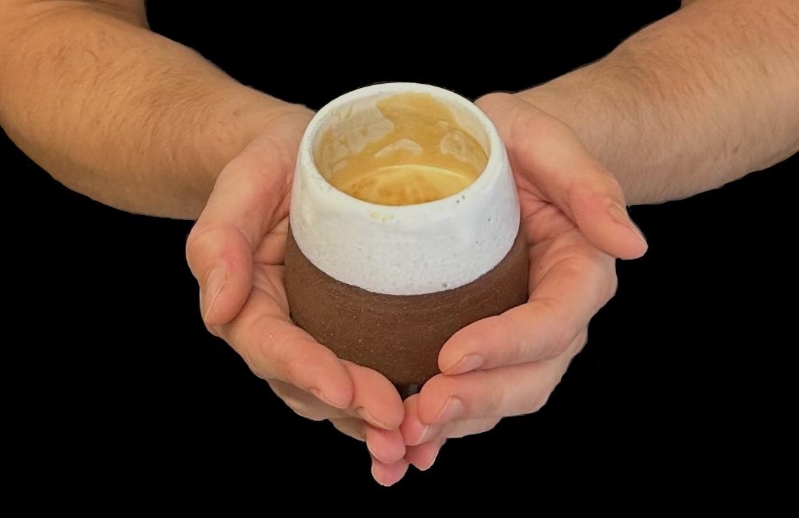 Close-up of hands working with pottery